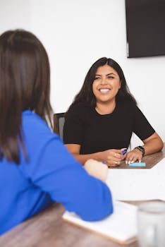 Smiling Woman Looking at her Colleague